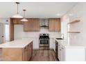 Modern kitchen with sleek countertops, stainless steel appliances, and contemporary lighting fixtures at 3910 W Kings Ave, Phoenix, AZ 85053