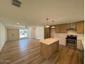 Open floor plan of living room and kitchen with natural light at 3910 W Kings Ave, Phoenix, AZ 85053