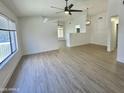 Bright and airy living room features modern ceiling fans, neutral paint, and beautiful vinyl plank flooring at 4050 E Agave Rd, Phoenix, AZ 85044