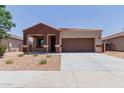 Charming single-story home boasts a well-manicured front yard and a two car garage enhancing its curb appeal and convenience at 41041 W Somers Dr, Maricopa, AZ 85138