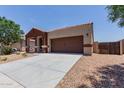 Charming single-story home boasts a well-manicured front yard and a two car garage enhancing its curb appeal and convenience at 41041 W Somers Dr, Maricopa, AZ 85138