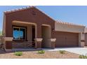Charming single-story home boasts a well-manicured front yard and a two car garage enhancing its curb appeal and convenience at 41041 W Somers Dr, Maricopa, AZ 85138