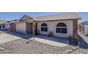 A well-maintained home with a desert landscape and a spacious concrete driveway and walkway at 450 N 110Th St, Mesa, AZ 85207