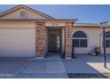 This beautiful home has a charming brick entryway and a well-manicured, desert-style front yard at 450 N 110Th St, Mesa, AZ 85207