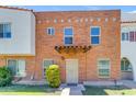 Charming brick townhouse with a tiled entryway canopy and a well-maintained front lawn at 527 N Lesueur --, Mesa, AZ 85203