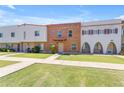 View of townhouses with green lawns, sidewalks, and unique architectural designs at 527 N Lesueur --, Mesa, AZ 85203