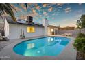 Lush backyard showcasing a sparkling pool, solar panels, and patio area, ideal for enjoying the outdoors at 6201 E Waltann Ln, Scottsdale, AZ 85254