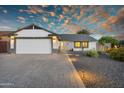 Charming single-Gathering home featuring a well-manicured front yard, desert landscaping, and a two-car garage at 6201 E Waltann Ln, Scottsdale, AZ 85254