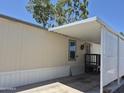 Angle view of covered carport of the mobile home, with space for car and storage at 7920 W Glendale Ave # 39, Glendale, AZ 85303