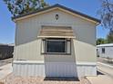 Front exterior of the mobile home with nice window awning detail at 7920 W Glendale Ave # 39, Glendale, AZ 85303