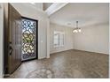 Welcoming foyer with decorative tile and staircase with natural light at 1125 E San Carlos Way, Chandler, AZ 85249