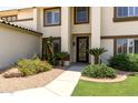 Beautifully landscaped front entrance with mature plantings and a decorative security screen door at 1125 E San Carlos Way, Chandler, AZ 85249