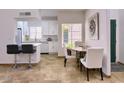 Cozy dining area featuring a modern bar area and sleek white cabinets at 11333 N 92Nd St # 1118, Scottsdale, AZ 85260