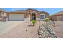 Charming home featuring a low maintenance desert landscape and wide driveway with a two car garage at 1144 E Nunneley Rd, Gilbert, AZ 85296