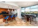Gourmet kitchen features sleek countertops, custom cabinetry, and an adjacent breakfast bar with comfortable seating at 120 E Rio Salado E Pkwy # 102, Tempe, AZ 85281