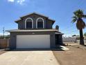 Charming two-story home with a two-car garage and palm tree at 121 N Brown Ave, Casa Grande, AZ 85122