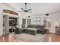 Spacious living room featuring a large sectional sofa, plantation shutters, and modern lighting at 1282 N Banning St, Gilbert, AZ 85234