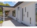 Close-up of the modern-style front door with sleek lines and a covered entry, showcasing contemporary design at 1367 E Mitchell Dr, Phoenix, AZ 85014