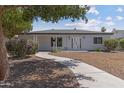 Charming single-story home with a curving walkway, desert landscaping, and modern architectural design at 1367 E Mitchell Dr, Phoenix, AZ 85014
