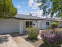 Single-story house showcasing desert landscaping, complemented by white trim and a well-maintained lawn at 1367 E Mitchell Dr, Phoenix, AZ 85014