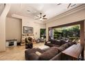 Spacious living room with a fireplace, comfortable seating, and sliding doors leading to the outdoor living area at 14598 E Corrine Dr, Scottsdale, AZ 85259