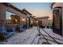 Cozy patio with comfortable seating, complemented by stylish decor and wrought iron doors providing seamless indoor-outdoor living at 14598 E Corrine Dr, Scottsdale, AZ 85259