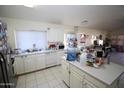 Open concept kitchen with island, tile floors, and stainless steel fridge at 16251 N 91St Dr, Peoria, AZ 85382