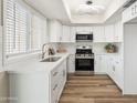 Contemporary kitchen featuring stainless steel appliances, white subway tile backsplash, and modern lighting fixtures at 1808 W Rose Ln, Phoenix, AZ 85015