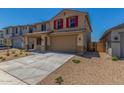 Charming two-story home featuring a two-car garage, red shutters, and desert landscaping at 18351 W Patrick Ln, Surprise, AZ 85387