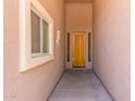 Inviting entryway with a wood front door, window, and neutral paint at 18449 W Piedmont Rd, Goodyear, AZ 85338