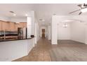 Inviting open-concept living space featuring a breakfast bar, neutral tile floors and modern archways throughout at 18449 W Piedmont Rd, Goodyear, AZ 85338
