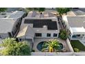 Overhead shot of a property with a pool, solar panels, and tile roof, set in a desirable neighborhood at 1865 E Locust Pl, Chandler, AZ 85286