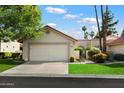 Charming single-story home with a two-car garage, well-maintained lawn, and attractive landscaping at 18780 N 94Th Ave, Peoria, AZ 85382