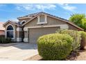 Inviting home exterior features a well-maintained yard and two-car garage at 20038 N 38Th Ln, Glendale, AZ 85308