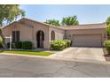 Charming single-story home features a well-manicured lawn and an attached two-car garage at 2063 S Edgewater --, Mesa, AZ 85209