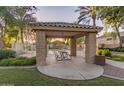Relaxing outdoor picnic area with a tile roof, seating, and a view of the community pool at 2063 S Edgewater --, Mesa, AZ 85209