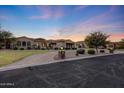 Beautiful home exterior with well-manicured lawn and inviting circular driveway at twilight at 26204 S Washington St, Chandler, AZ 85249