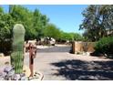 Community gate with desert plants creates an inviting, secluded entrance to the property at 38065 N Cave Creek Rd # 2, Cave Creek, AZ 85331