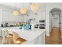 Bright kitchen featuring white cabinetry, a center island, and stylish pendant lighting at 3917 E Patrick Ln, Phoenix, AZ 85050