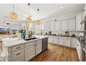Modern white kitchen featuring a large island, stainless steel appliances, and open layout at 3917 E Patrick Ln, Phoenix, AZ 85050