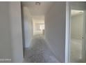 A long hallway is shown going to the back of the house at 46868 W Old Timer Rd, Maricopa, AZ 85139