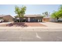 Inviting front yard with stone accents and extra long driveway for additional parking at 5637 N 63Rd Dr, Glendale, AZ 85301