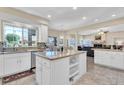 Bright kitchen with granite countertops, island, tile flooring, and stainless steel appliances at 6376 W Louise Dr, Glendale, AZ 85310