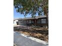 Charming single-story home with desert landscaping, block wall, and mature trees, providing shade at 6429 W Palm Ln, Phoenix, AZ 85035
