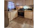 Functional kitchen with white cabinets, stainless steel appliances, and a gas range oven at 6733 W Sherri Jean Ln, Peoria, AZ 85382
