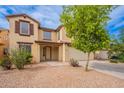 Charming two-story home with a two-car garage, desert landscaping, and a covered front porch at 694 W Desert Seasons Dr, San Tan Valley, AZ 85143