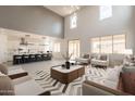 Spacious living room with high ceilings, clerestory windows, modern decor, and an open floor plan at 694 W Desert Seasons Dr, San Tan Valley, AZ 85143