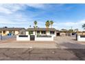 Inviting single-story home with a well-kept yard, a privacy fence, and covered parking, exuding charm and functionality at 7502 W Cora Ln, Phoenix, AZ 85033