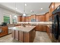 Spacious kitchen with granite countertops, stainless steel appliances, tile floors, and ample cabinet space at 7939 W Fetlock Trl, Peoria, AZ 85383