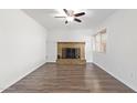 Spacious living room featuring beautiful brick fireplace and modern flooring that enhances this living space at 8807 W Cinnabar Ave, Peoria, AZ 85345